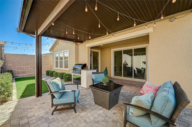 view of patio / terrace featuring a grill, an outdoor living space, and exterior kitchen