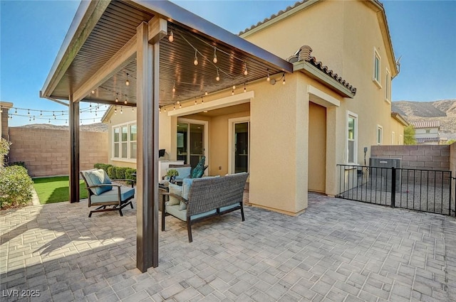 back of house with an outdoor hangout area, a patio area, and a mountain view