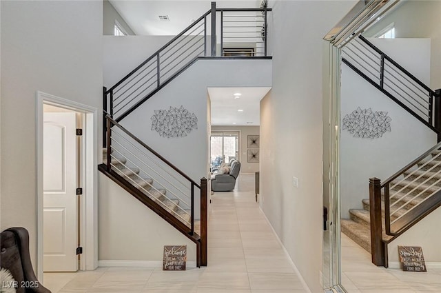 tiled entryway featuring a high ceiling