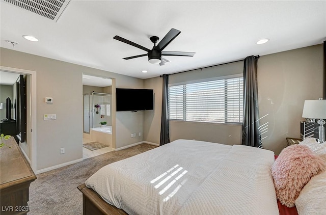 bedroom with ceiling fan, connected bathroom, and light carpet