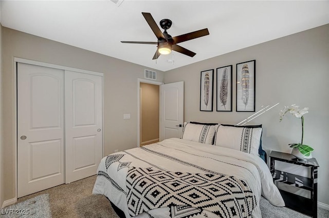 carpeted bedroom with a closet and ceiling fan