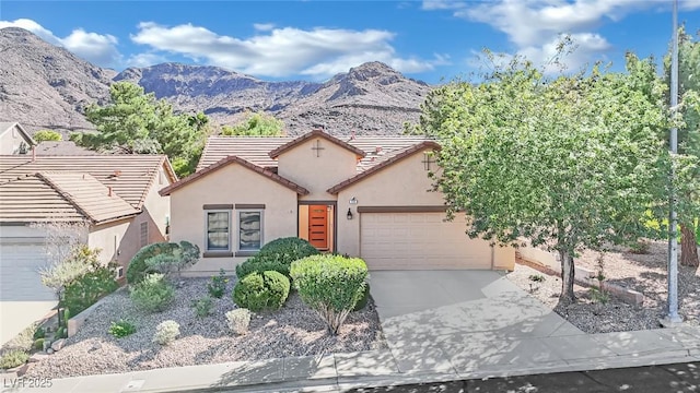 view of front facade with a garage and a mountain view