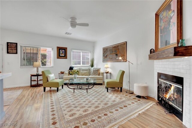 living room featuring ceiling fan and light wood-type flooring