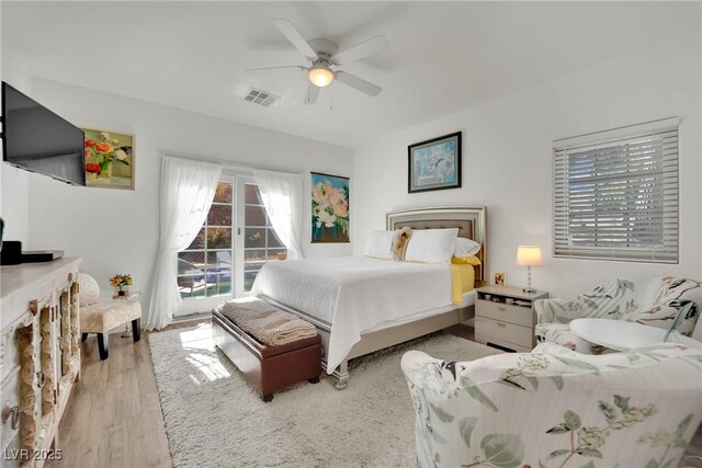 bedroom featuring access to exterior, ceiling fan, and light wood-type flooring