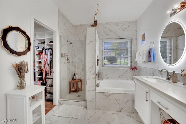 bathroom with vanity and separate shower and tub