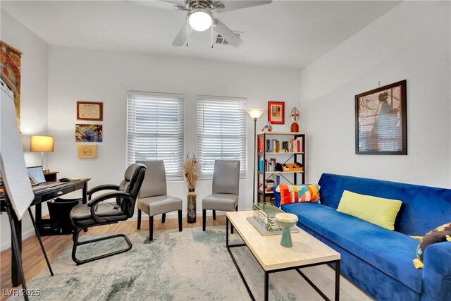 living room featuring light hardwood / wood-style floors and ceiling fan