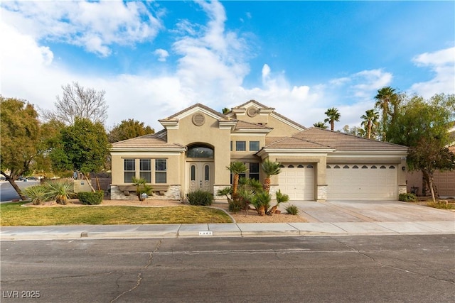 mediterranean / spanish-style house with a garage