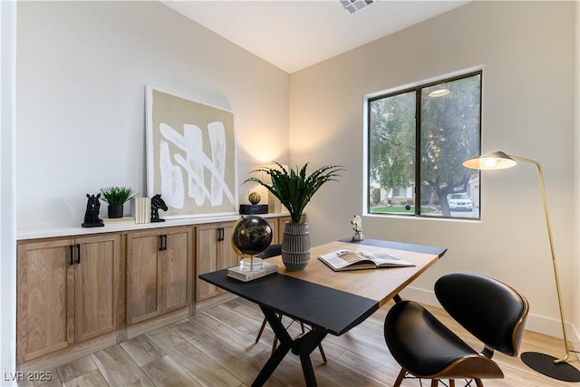 office space with light hardwood / wood-style flooring