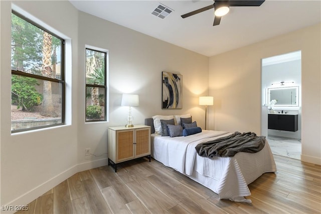 bedroom with connected bathroom, ceiling fan, and light wood-type flooring