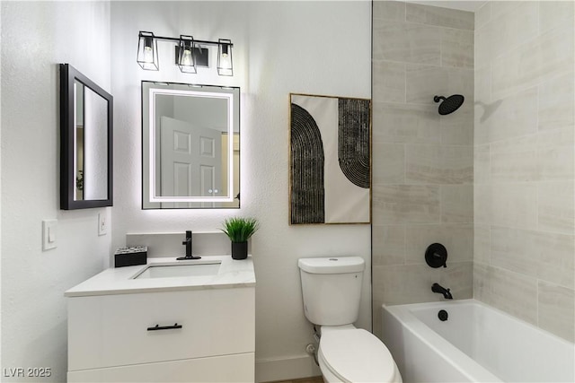 full bathroom featuring tiled shower / bath combo, vanity, and toilet