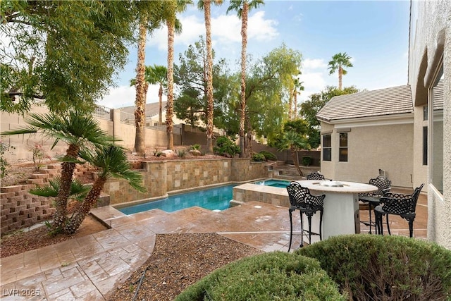 view of pool featuring an in ground hot tub, exterior bar, and a patio