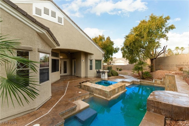 view of pool featuring an in ground hot tub