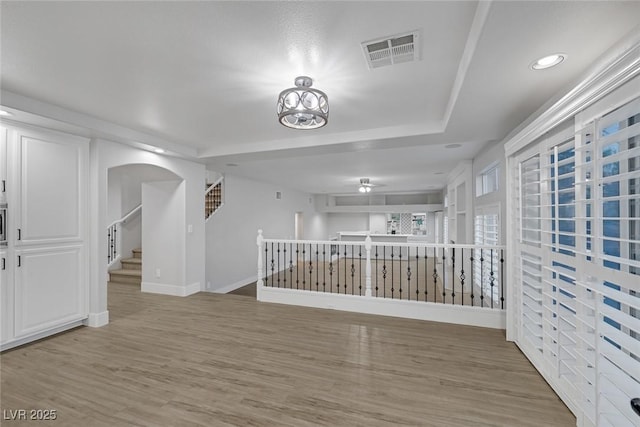 spare room with hardwood / wood-style flooring and a chandelier