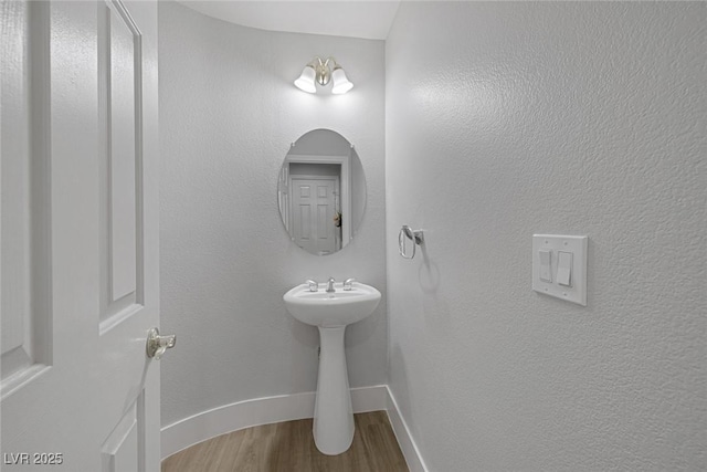 bathroom with hardwood / wood-style flooring