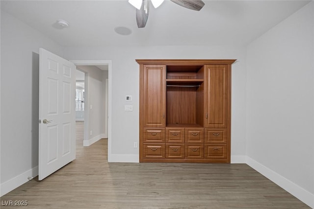 unfurnished bedroom with ceiling fan and light hardwood / wood-style flooring