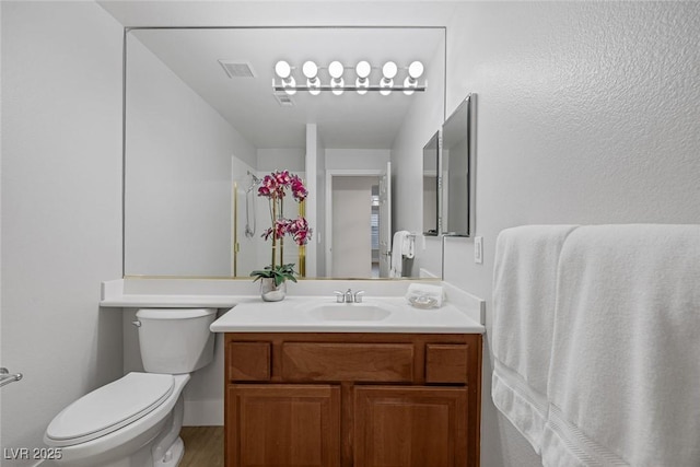 bathroom featuring vanity, toilet, and wood-type flooring