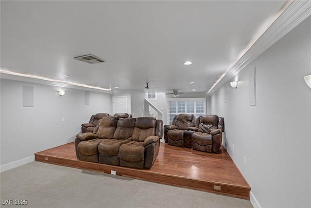 carpeted home theater featuring ceiling fan