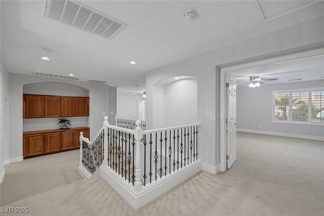 hallway featuring light colored carpet