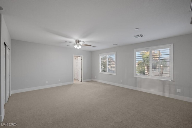 unfurnished bedroom with light colored carpet and ceiling fan