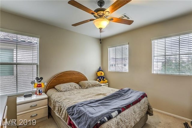 bedroom with ceiling fan and light colored carpet