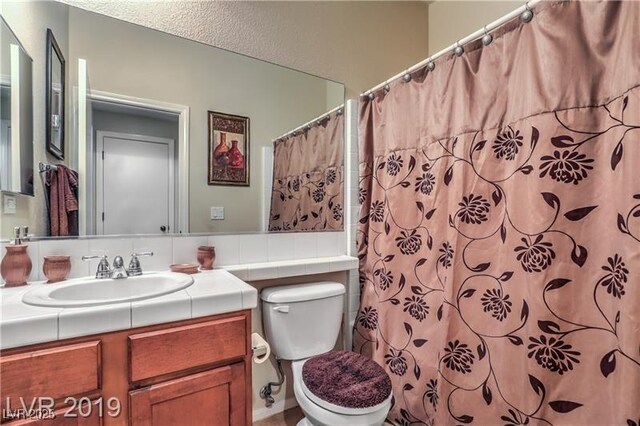 bathroom with vanity, toilet, and a shower with shower curtain