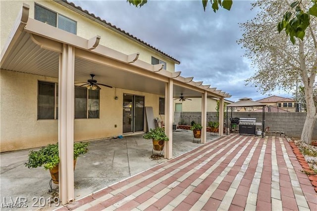 view of patio / terrace featuring a gazebo, a grill, and ceiling fan