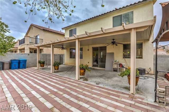 back of house with ceiling fan and a patio area