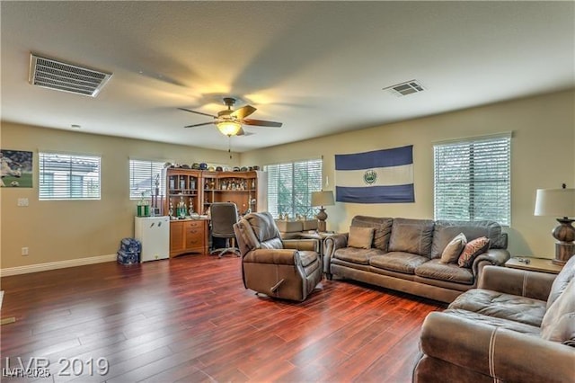 living room featuring ceiling fan and dark hardwood / wood-style flooring