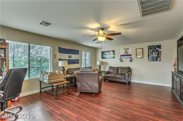 living room with dark hardwood / wood-style floors and ceiling fan