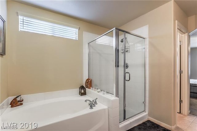 bathroom featuring shower with separate bathtub and tile patterned floors