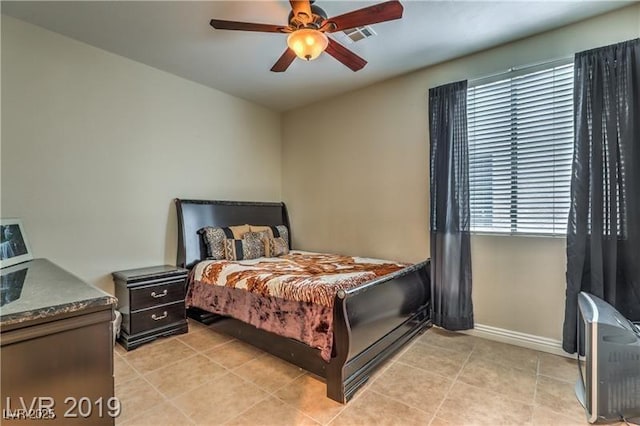 tiled bedroom with ceiling fan