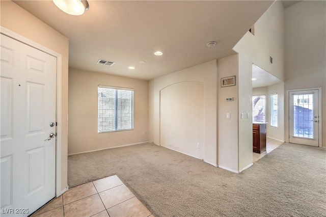 foyer with a healthy amount of sunlight and light carpet