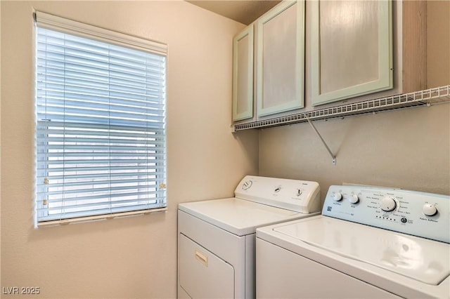 laundry room with cabinets and washing machine and dryer