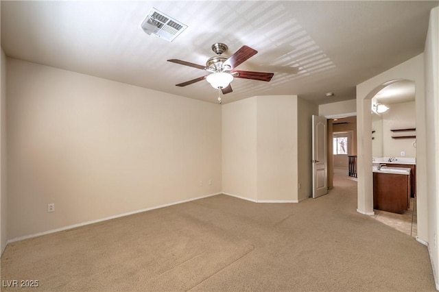 carpeted spare room featuring ceiling fan