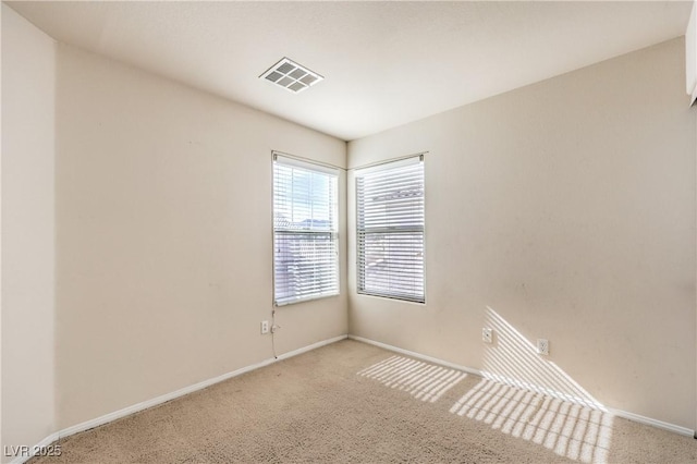 spare room featuring light colored carpet