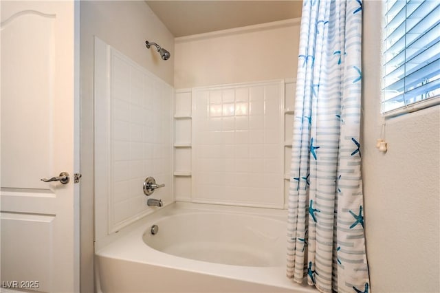 bathroom with shower / bath combo with shower curtain