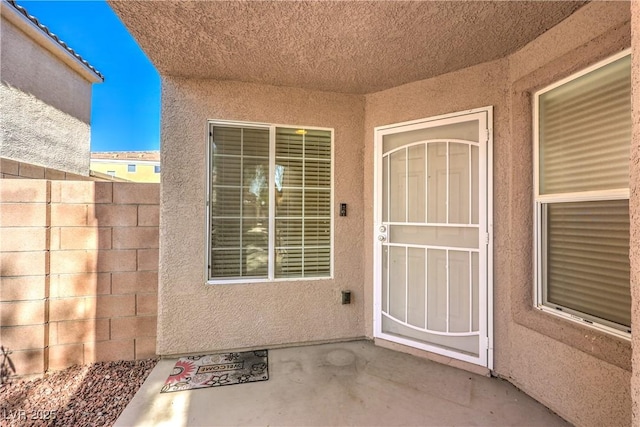 property entrance featuring a patio