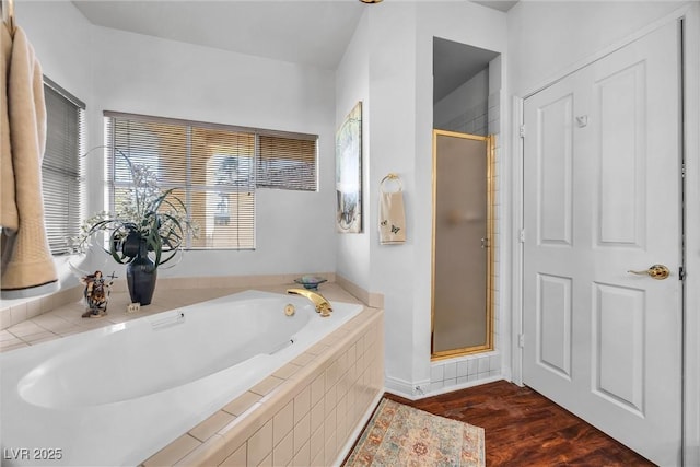 bathroom with hardwood / wood-style flooring and an enclosed shower