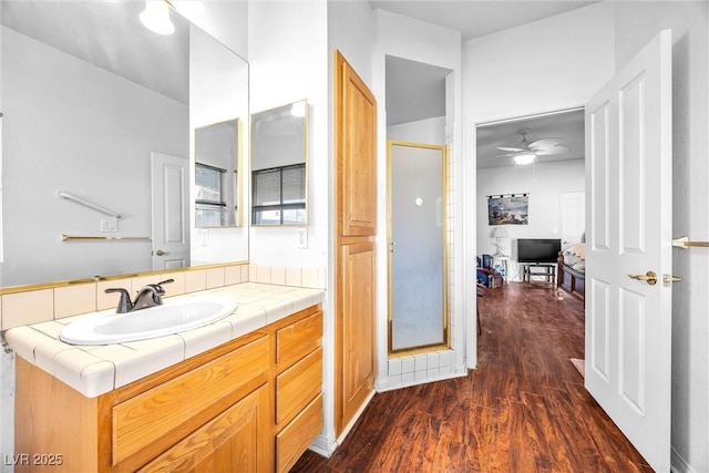 bathroom featuring vanity, hardwood / wood-style floors, ceiling fan, and an enclosed shower