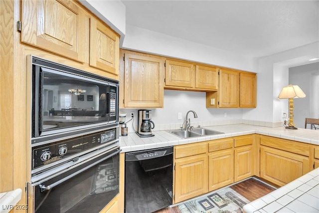 kitchen featuring sink, tile counters, black appliances, and light brown cabinets