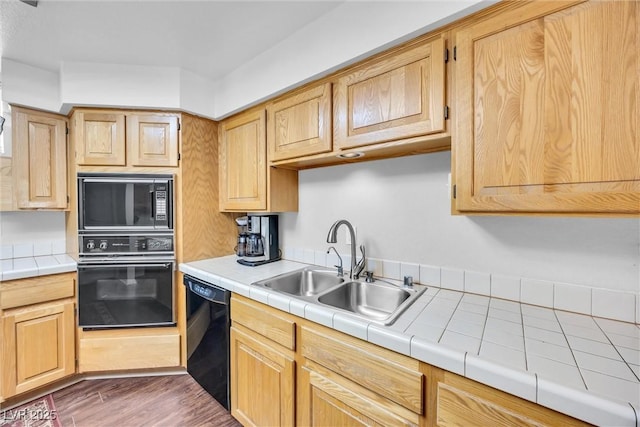 kitchen featuring dark wood-type flooring, sink, light brown cabinets, tile counters, and black appliances