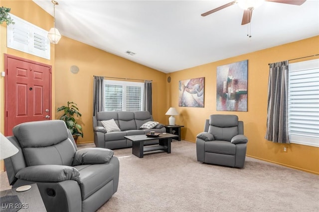 carpeted living room featuring ceiling fan and vaulted ceiling