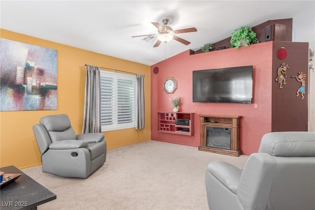 carpeted living room with ceiling fan and lofted ceiling