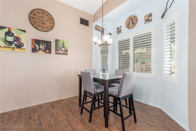 dining area with an inviting chandelier and dark wood-type flooring