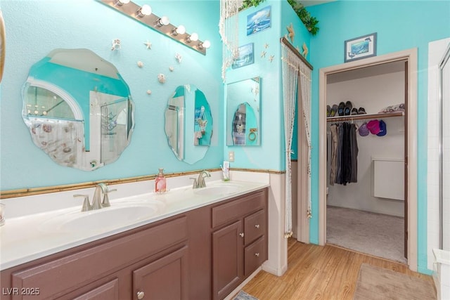 bathroom featuring vanity, hardwood / wood-style floors, and walk in shower