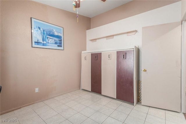 empty room featuring ceiling fan and light tile patterned floors