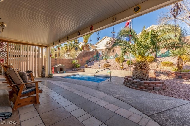 view of patio / terrace with a fenced in pool