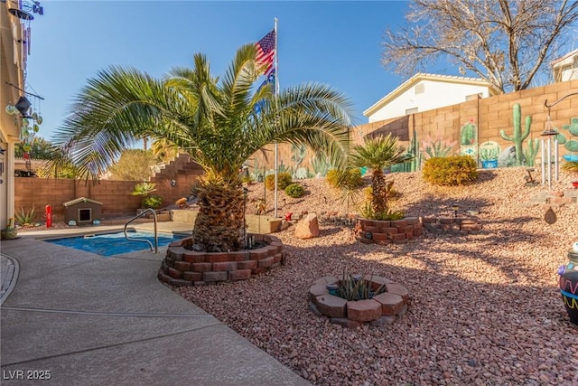 view of swimming pool featuring a fire pit and a patio area