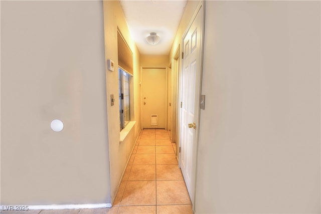 corridor featuring light tile patterned floors