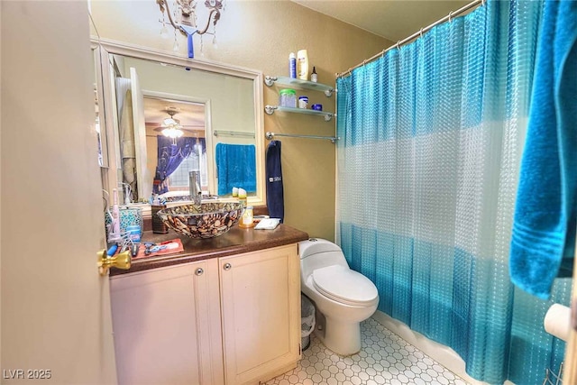 full bathroom featuring shower / bath combination with curtain, ceiling fan, vanity, and toilet